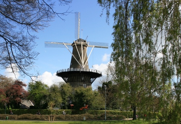 Picturesque canal in Delft, Netherlands with boats and autumn trees